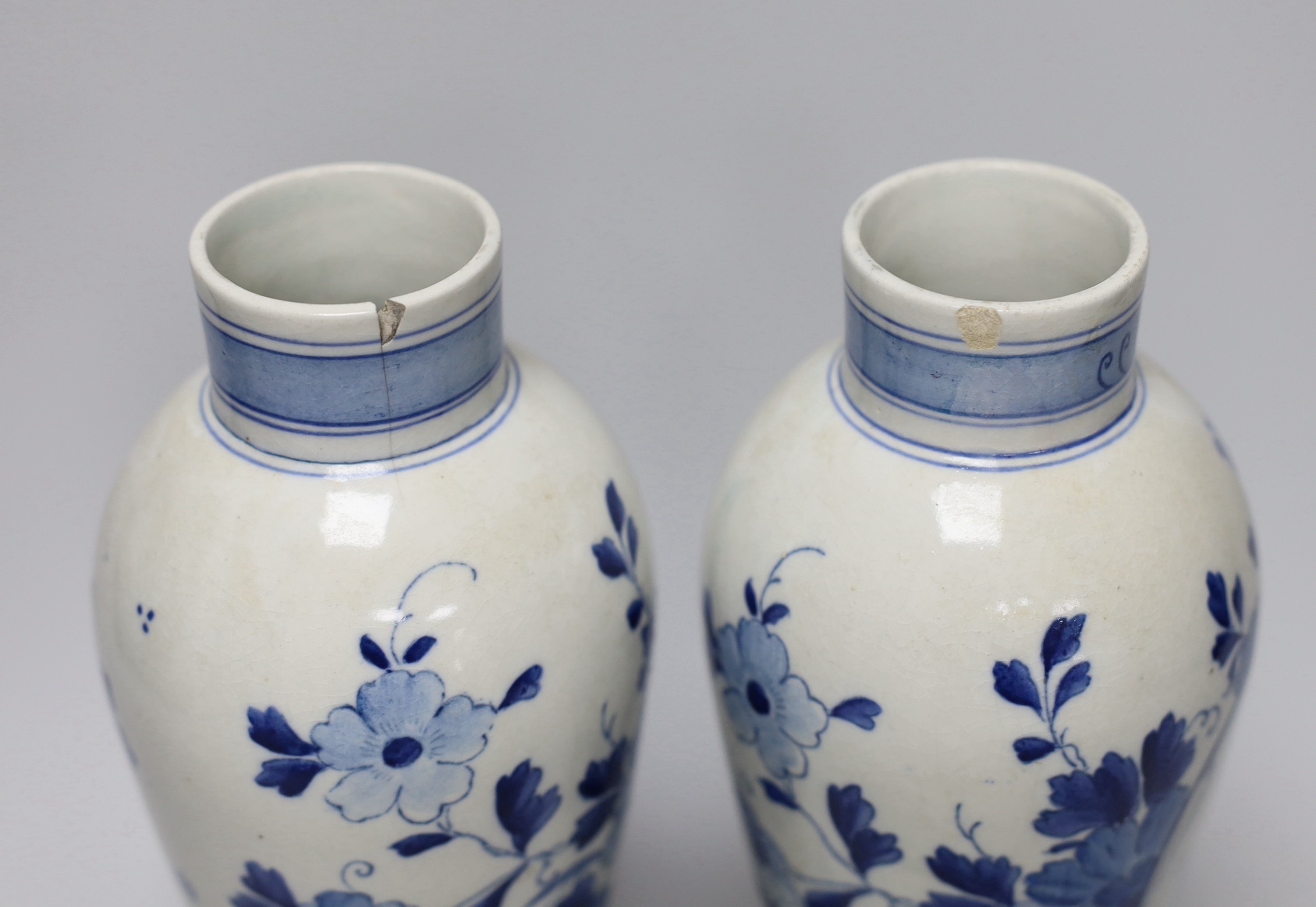 A pair of blue and white Delft vases and covers, 28cm
